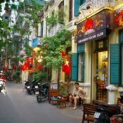 The authentic street culture of Hanoi's Old Quarter, captured in a photo of a local flower vendor's bicycle laden with beautiful fresh flowers.